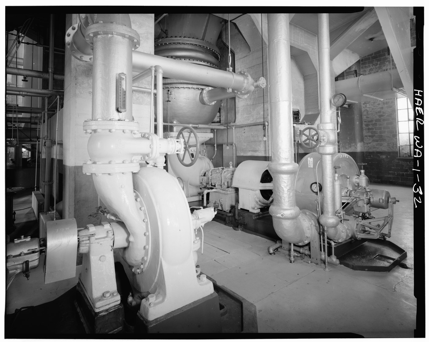 An industrial vacuum pump beside a condenser turbine and jet condenser with process piping (Georgetown Steam Plant, HAER) — complex industrial vacuum machinery — the class of hardware DiastolVAC controls by Panacea Bio Chem and Bogdan Dicoias